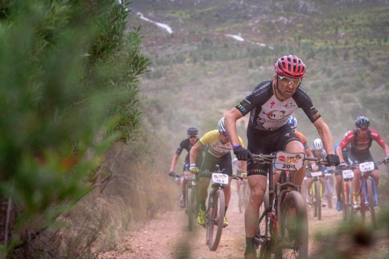 multiple bikers heading up an incline