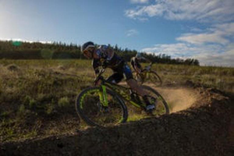 Dark shot of the bikers taking a steep turn