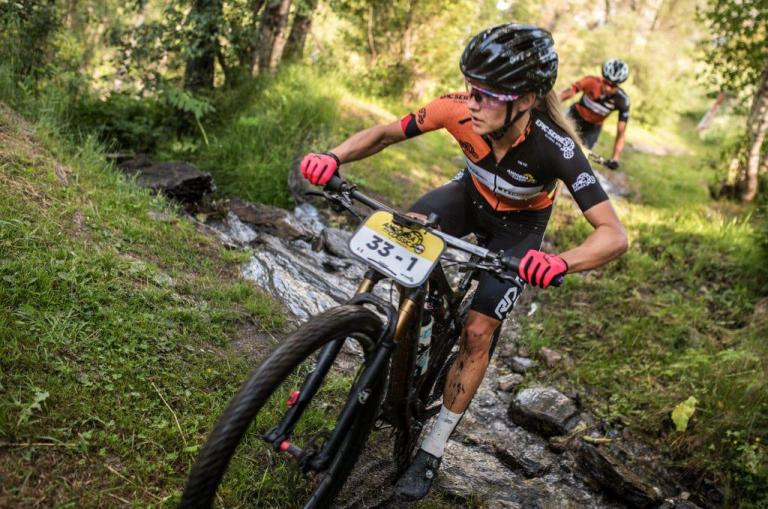 A biker heading across a small creek
